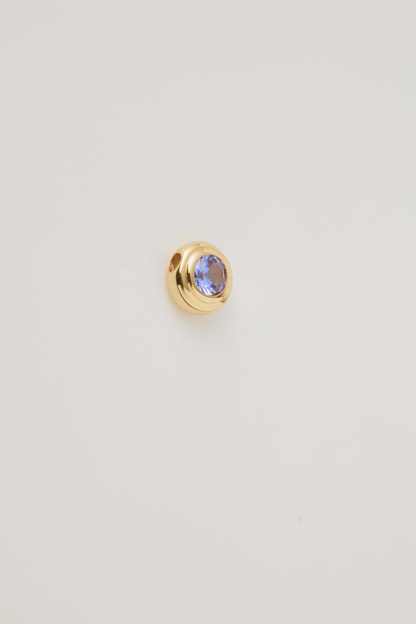 Sie view image of the December Birthstone Charm featuring a stunning tanzanite gemstone with deep blue and violet hues in a polished gold setting.