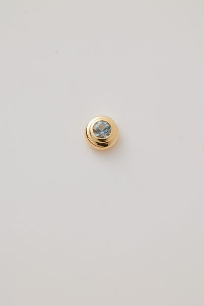 Close-up image of a March Birthstone Charm featuring a serene aquamarine gemstone in a sleek gold setting, showcasing soft blue tones. 