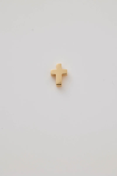 A delicate Christian cross charm crafted from polished 18-karat gold. The charm features clean, elegant lines with a smooth, shiny finish that reflects light beautifully. Its minimalist design emphasises simplicity and sophistication, making it a versatile accessory for both everyday wear and special occasions. The hole at the top allows easy chain threading a chain or bracelet.