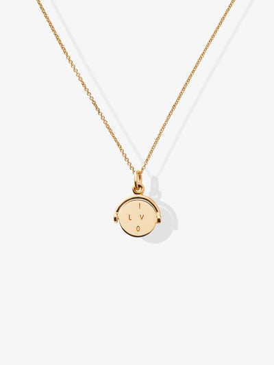 Introducing the "I Love You Necklace in 18k Gold," featuring a delicate chain and a meaningful charm pendant. The circular pendant is engraved with the letters "I," "L," "V," and "O" arranged in a square pattern, creating a heartfelt design. This exquisite 18-karat gold necklace is beautifully showcased against a plain, white background.