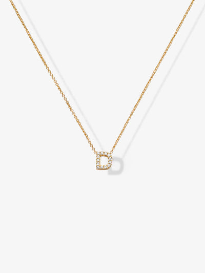 Product Description: 
The Letter D Necklace in Diamonds and 18k Gold features a delicate chain crafted from 18k gold, adorned with a small, sparkling pendant shaped like the letter "D." The pendant is encrusted with tiny, clear, round-cut gemstones that enhance the minimalist design with a touch of elegance. This exquisite diamond letter necklace stands out beautifully against a plain white background.