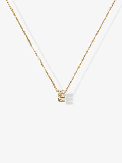 The "Letter E Necklace in Diamonds and 18k Gold" is a delicate piece of personalized jewelry featuring a small pendant shaped like the letter 'E,' adorned with tiny, sparkling diamonds against a plain white background. This exquisite necklace adds a touch of elegance to any ensemble.