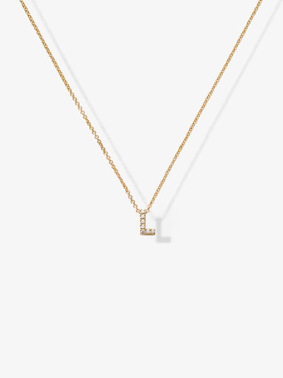 The Letter L Necklace in Diamonds and 18k Gold is a delicate piece featuring a small pendant shaped like the letter "L" encrusted with tiny crystals. This customizable charm necklace hangs from a thin gold chain against a plain white background.