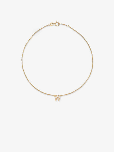 An image of a delicate bracelet in 18k solid gold featuring a thin chain and a small "W" pendant in the center. The "W" is adorned with tiny, round brilliant diamonds. The bracelet is arranged in a circular shape against a plain white background, showcasing the exquisite craftsmanship of the Letter W Bracelet in Diamonds and 18k Gold.