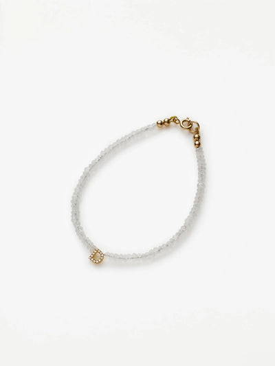 Hand-strung bracelet with natural rainbow moonstone gemstones and miniature three-dimensional diamond letter in 18k solid gold