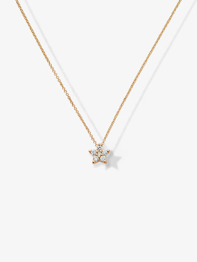 The One Diamond Star Necklace in 18k Gold showcases a stunning diamond star-shaped pendant adorned with small, sparkling diamonds. This delicate and elegant piece hangs centered on a thin gold chain, beautifully photographed against a plain white background.