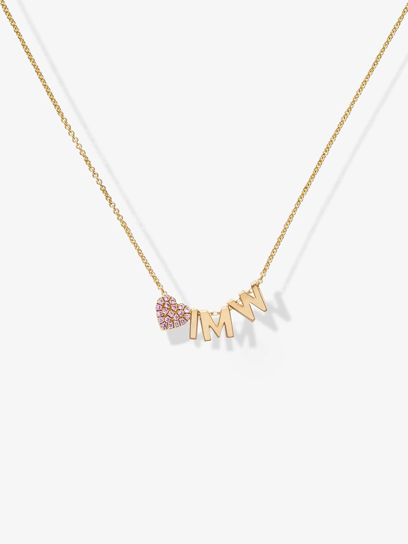 Introducing the "Three Letters and Pink Sapphire Heart Necklace in 18k Gold": This elegant gold necklace features customizable charms—a small pink sapphire heart and the letters "M," "I," and "N." Arranged to spell "MIN" with the heart preceding them, these charms dangle from a delicate and stylish 18k solid gold chain.