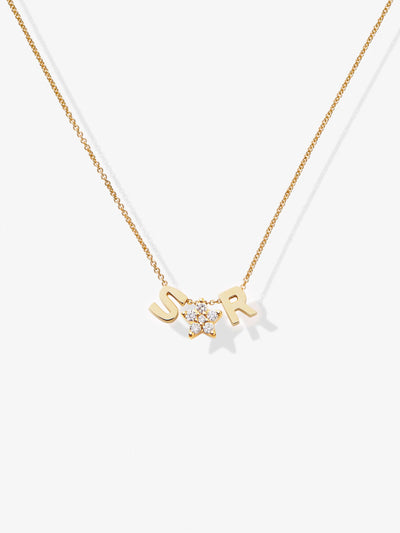 The "Two Letters and Diamond Star Necklace in 18k Gold" is a delicate piece showcasing two letter charms "S" and "R" flanking a radiant star-shaped charm adorned with clear gemstones, all elegantly suspended from a fine gold chain against a white background.