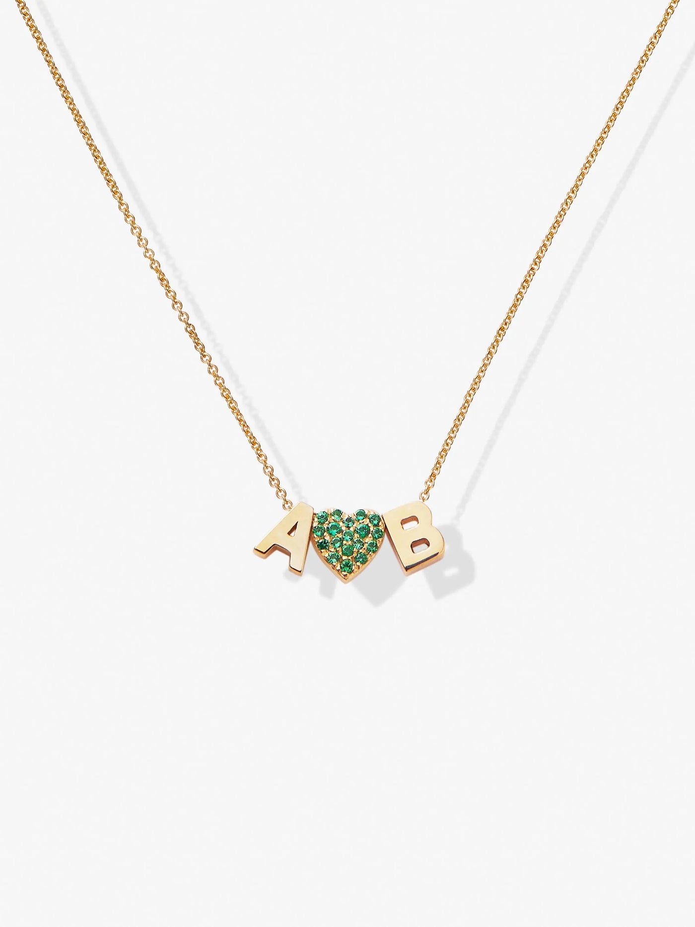 Product Data: Two Letters and Tsavorite Heart Necklace in 18k Gold

The Two Letters and Tsavorite Heart Necklace in 18k Gold showcases a delicate chain adorned with two letter charms, "A" and "B," separated by a tsavorite heart.