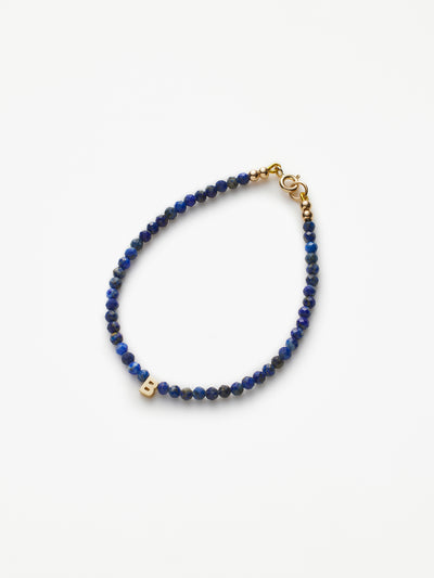 Hand-strung bracelet with natural lapis lazuli gemstones and miniature three-dimensional letter in 18k Solid gold