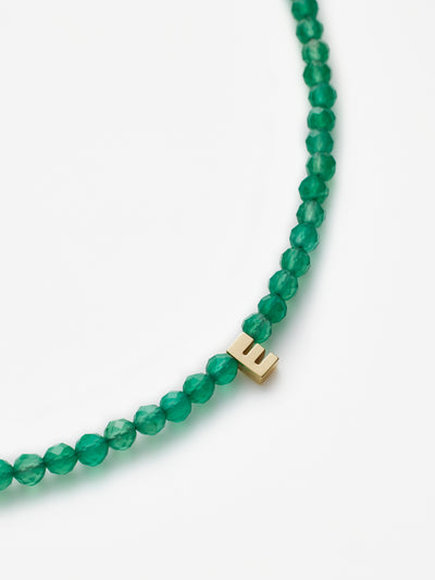 Hand-strung bracelet with natural green onyx gemstones and miniature three-dimensional letter in 18k solid gold