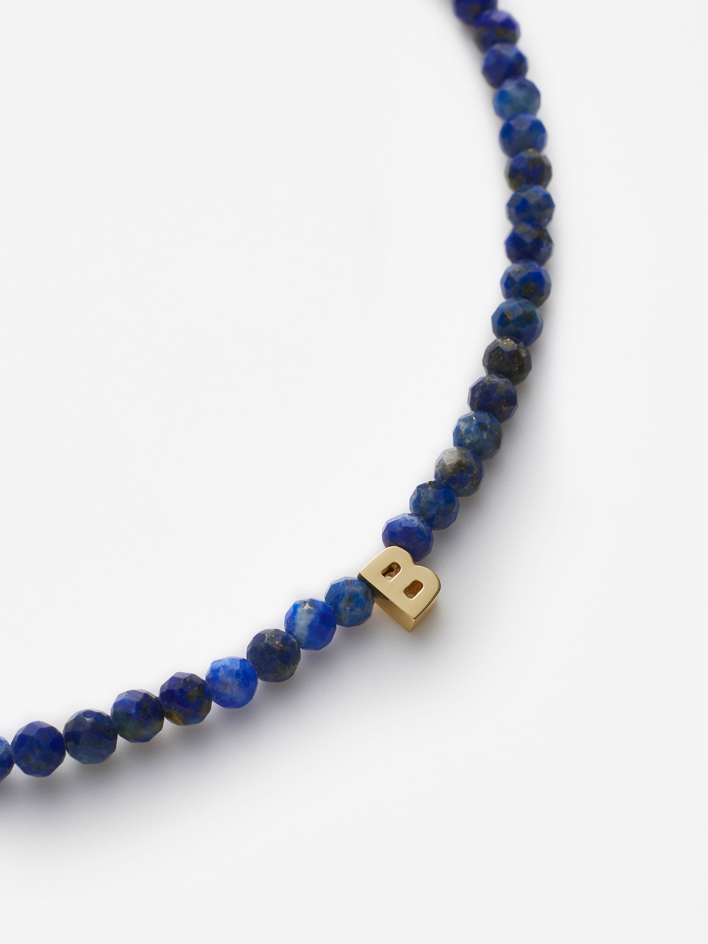 Hand-strung bracelet with natural lapis lazuli gemstones and miniature three-dimensional letter in 18k Solid gold