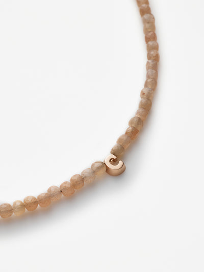 Hand-strung bracelet with natural moonstone gemstones and miniature three-dimensional letter in 18k solid rose gold